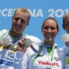 Winners Reichert, Harle and Lurz of Germany show their gold medals after the team event 5km open water race during the World Swimming Championships in Barcelona